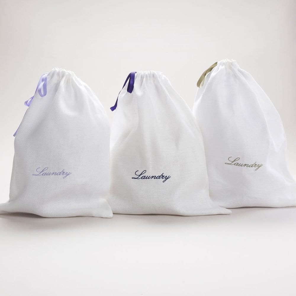 White drawstring hotel laundry bags embroidered 'Laundry'